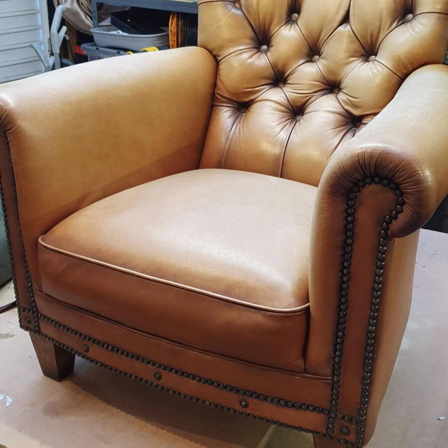 Tan leather armchair before restoration